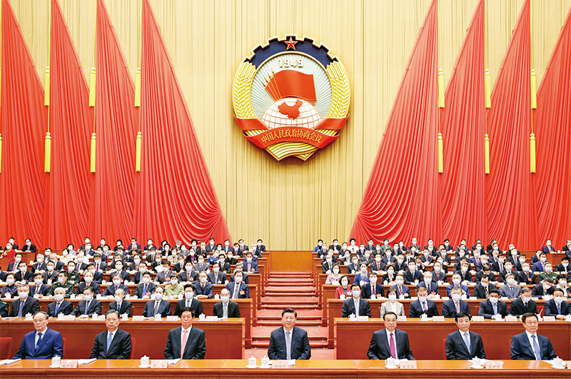 2022年3月4日，中國(guó)人民政治協(xié)商會(huì)議第十三屆全國(guó)委員會(huì)第五次會(huì)議在北京人民大會(huì)堂開幕。這是習(xí)近平、李克強(qiáng)、栗戰(zhàn)書、王滬寧、趙樂際、韓正、王岐山在主席臺(tái)就座，汪洋代表政協(xié)第十三屆全國(guó)委員會(huì)常務(wù)委員會(huì)向大會(huì)報(bào)告工作。　新華社記者 黃敬文/攝